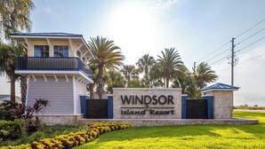 A sign for 'Windsor Island Resort' with a building and landscaped area in the foreground. - Adventure of a Lifetime! 5 BDR at Windsor Island (Davenport)