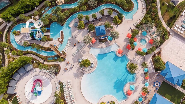 An aerial view of a resort with multiple swimming pools, water slides, and sun loungers. - Adventure of a Lifetime! 5 BDR at Windsor Island (Davenport)