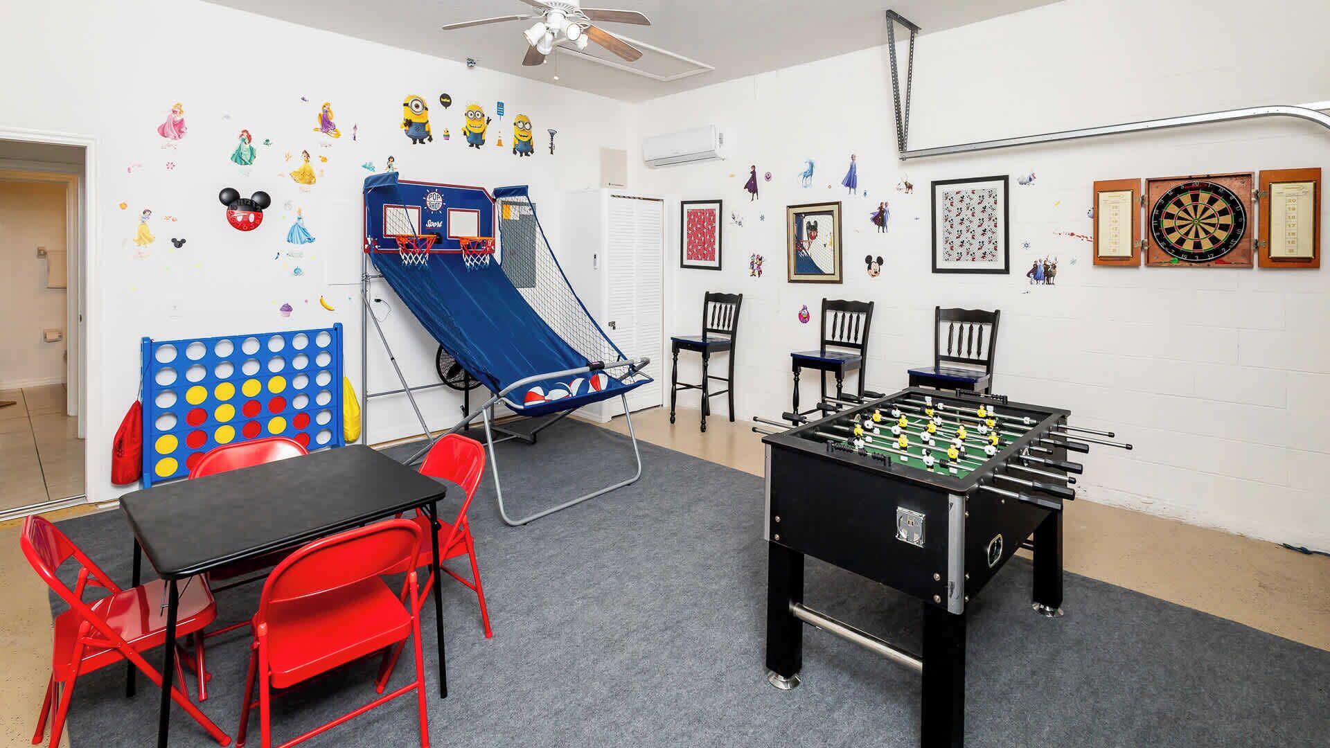 Une pièce équipée d’un baby-foot, d’un mur d’escalade bleu et d’une table de ping-pong.