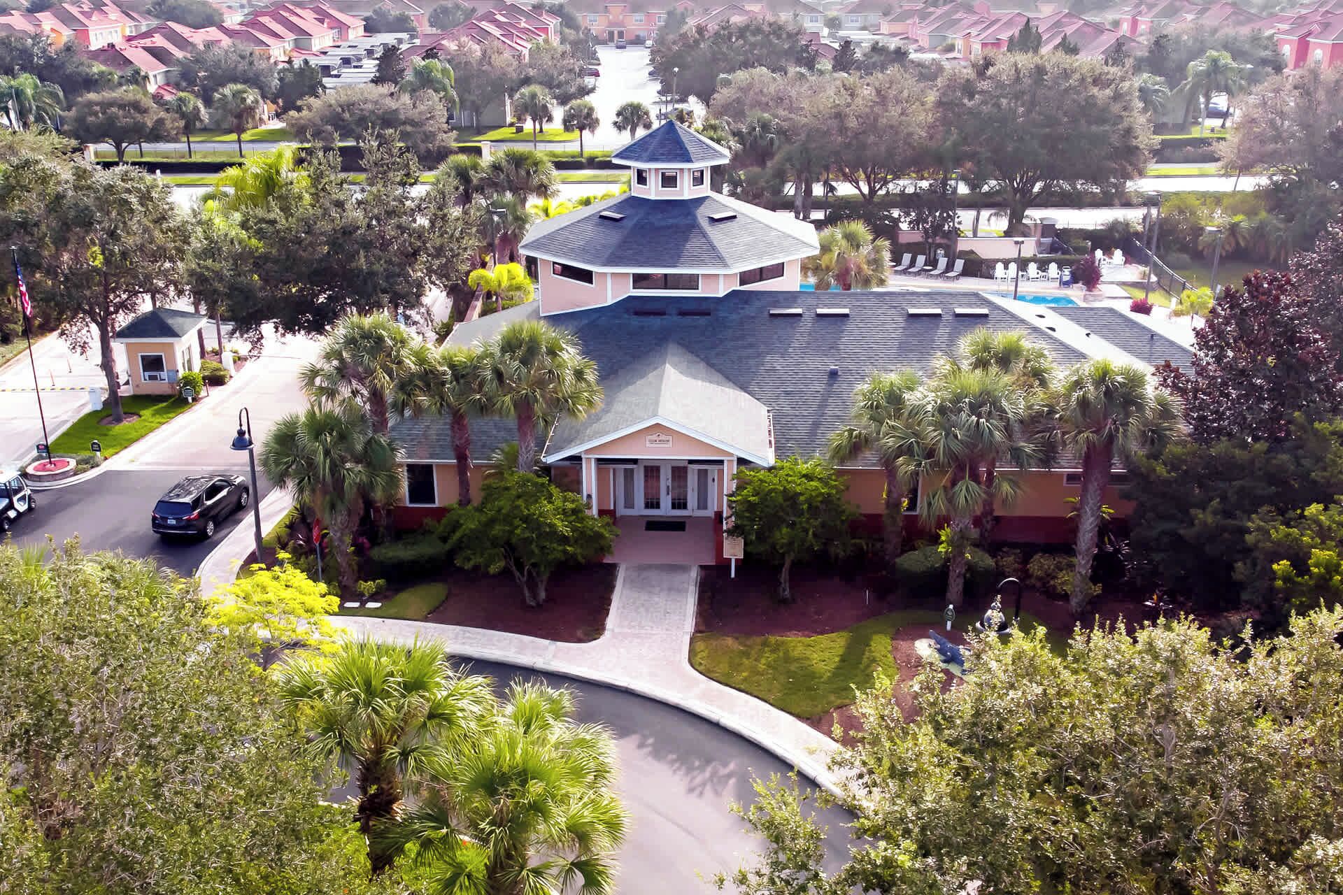 A large, multi-story building with a central dome and a covered patio area.