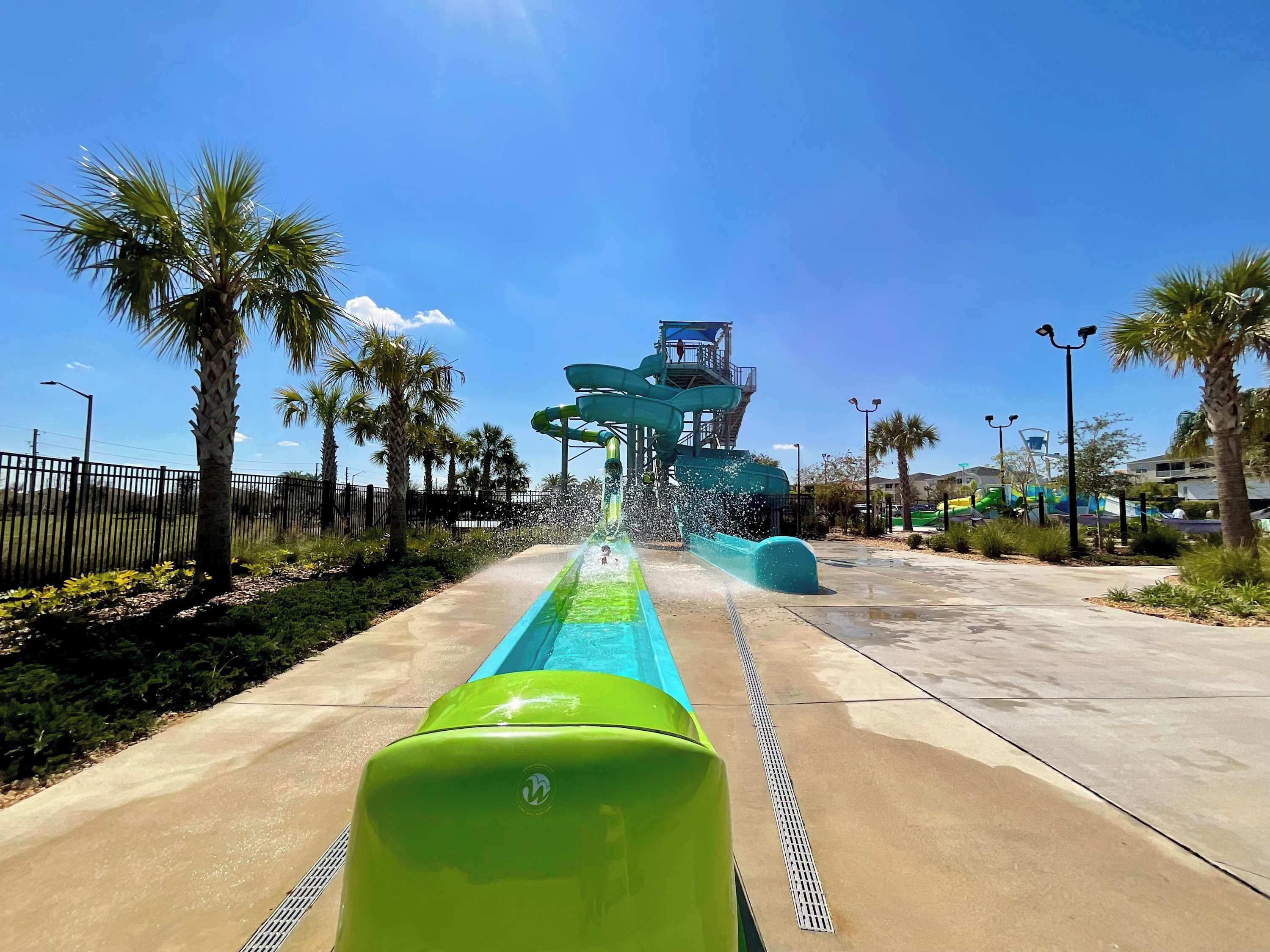 A water park with a large water slide and a pool area.