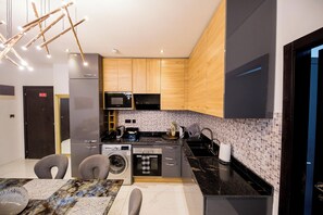 Microwave, oven, stovetop, dishwasher - The Signature Apartment by G&L Luxury Properties Unit A407-Charming 2 bedrooms (Accra)