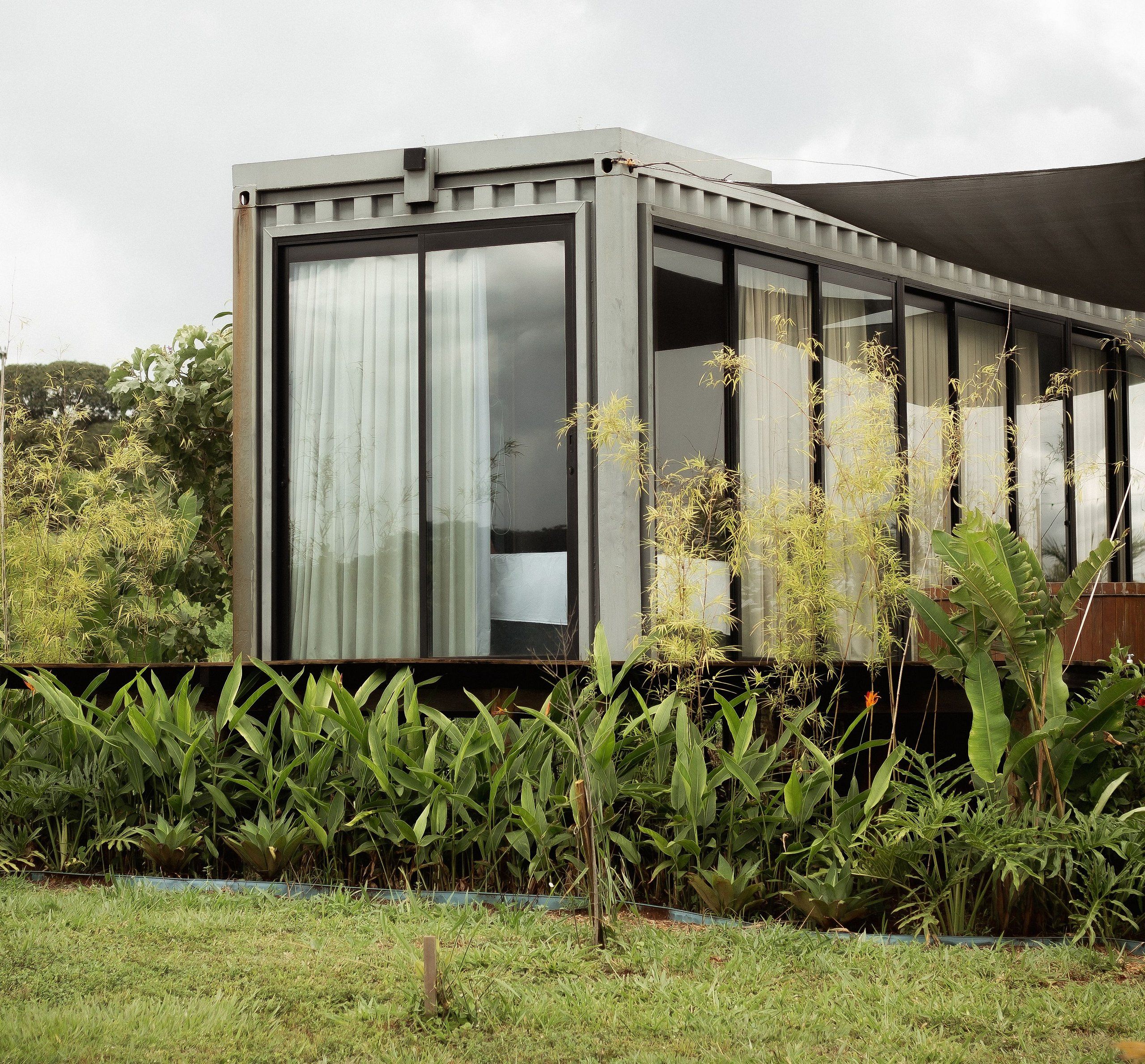 A modern building with large windows and a covered outdoor area.