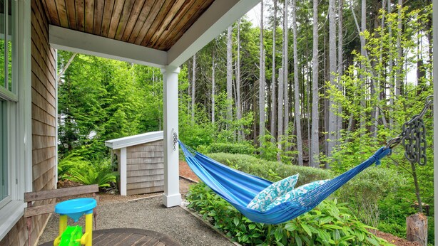 A hammock under a wooden porch with a view of a forest. - 5 min. Walk to Town & Beach, Greenbelt Views + Private Backyard (Pacific Beach)