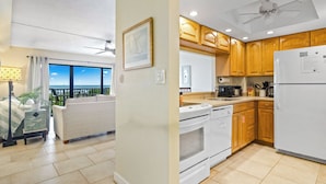 A living room with a sofa, a dining area with a table, and a kitchen with wooden cabinets and appliances.