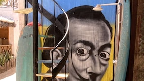 A staircase leading to a room with a mural of a face on the wall. - Trip Hostel e Pousada (Jericoacoara)