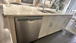 A kitchen with a granite countertop, stainless steel dishwasher, and white cabinets. - A/C, Fenced backyard , BBQ grill, pets welcome (Edmonton)