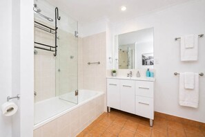 Shower, hair dryer, towels, shampoo