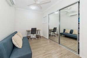 Relax in comfort with a sofa, dining table, and balcony access.