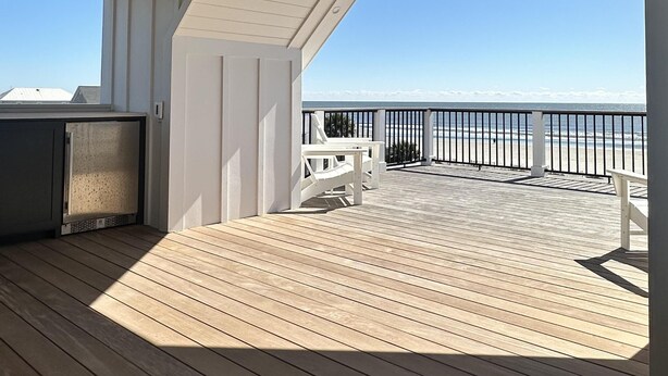 A wooden deck with a white railing, a seating area, and a view of the ocean. - The Lookout | Private Pool | Steps to Beach & Pier | Newly Built (Folly Beach)