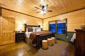Drift off in a cozy knotty-pine master bedroom that wraps you in rustic warmth. - BirchSquatch · Heated Pool: Putt-Putt, Gameroom, Playset, Sleeps 24! (Broken Bow)
