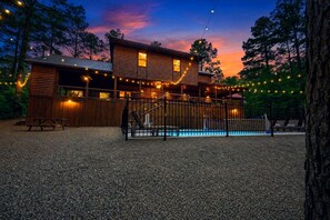 Nothing beats arriving to a glowing pool and a cabin lit up against a purple sunset. - BirchSquatch · Heated Pool: Putt-Putt, Gameroom, Playset, Sleeps 24! (Broken Bow)