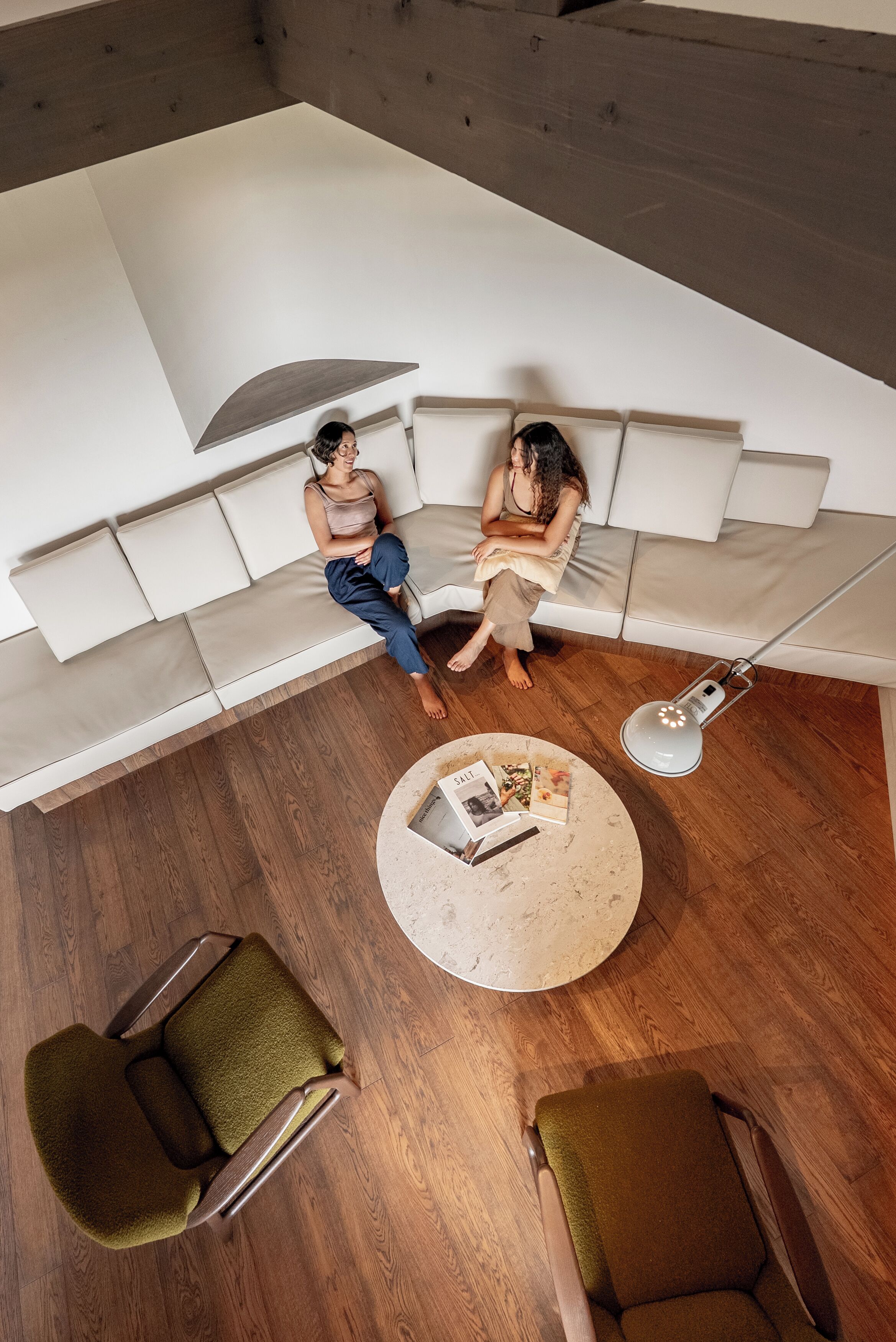 A modern living room with a sofa, two chairs, a coffee table, and a floor lamp.