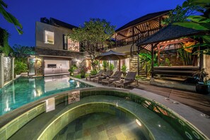 A modern villa with a swimming pool, outdoor seating, and a covered patio area. - Villa Bettini Stylish 3BR w/ Pool, Near Bintang (Badung)
