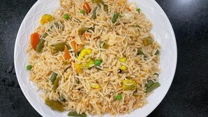 A plate of fried rice with vegetables. - Himalayan View stay (Mussoorie)
