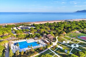 An aerial view of a resort with a large swimming pool, a beach, and lush greenery. - Perla Holiday Villa 150, Lalzit Bay, Albania (Lalzit Bay)