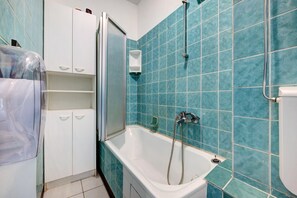A bathroom with a bathtub, a shower, and a toilet.