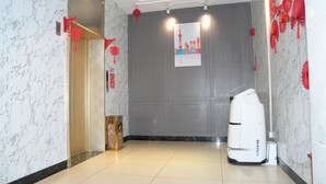 A hotel corridor with a marble wall, a closed elevator, and a white air purifier. - YESTE Hotel (Shenzhen Nanshan Qianhai Daxin subway station) (Shenzhen)