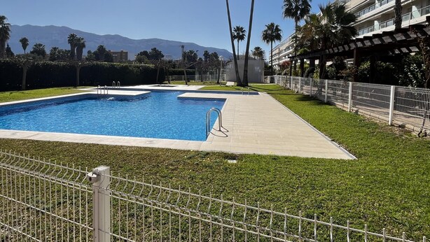 A swimming pool with a view of mountains in the background. - Flat Aguamar, ground floor, 1 bedroom, garden and swimming pool. (Dénia)