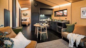 A modern interior with a dining area, kitchen, and seating space. - Skylark Cabin – Private Luxury Escape with Hot Tub (Ben Ohau)