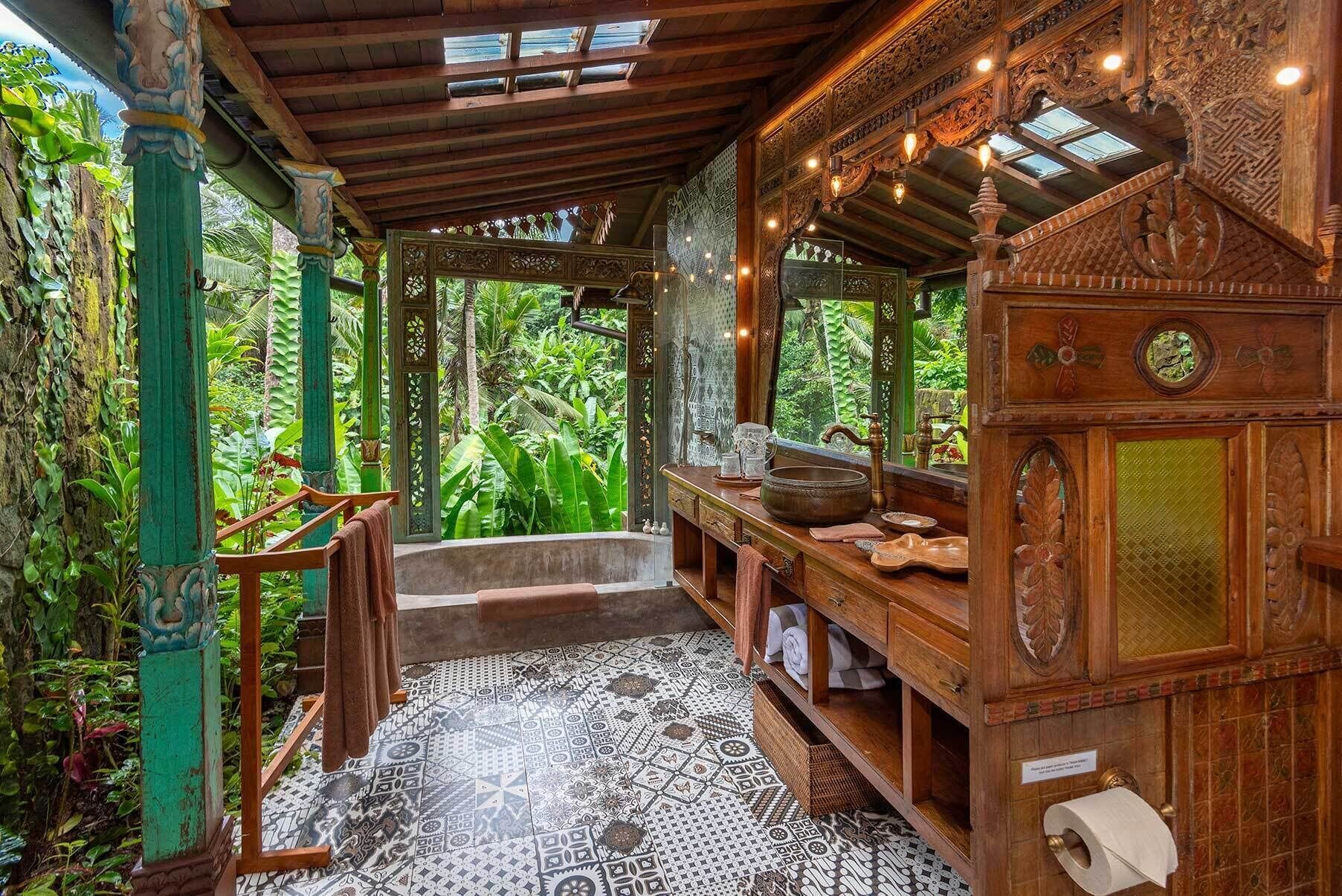 A traditional wooden bathroom with a patterned floor, a sink, and a mirror.
