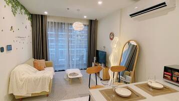 Standard Apartment, Balcony | Living area | 60-inch flat-screen TV with cable channels