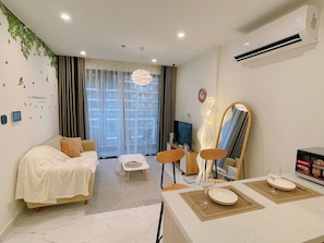 Standard Apartment, Balcony | Living area | 60-inch flat-screen TV with cable channels