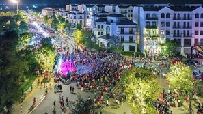 A large outdoor gathering in a public square with buildings in the background. - Vinhomes Grand Park Luxury Apartments  (Ho Chi Minh City)