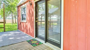 A red building with a wooden deck and a glass door. - Countryside Escape 14 Mi to Milford & Geary Lakes! (Chapman)