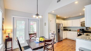 A modern kitchen with white cabinets, a granite countertop, and stainless steel appliances. - Deck & Yard: Savannah Area Retreat! (Pooler)