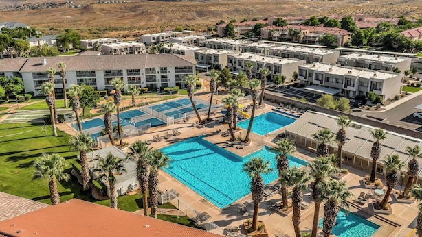 A resort with multiple swimming pools, palm trees, and a mountainous backdrop. - Best View! 6 Pools & 4 Hot Tubs! Waterslides! Sport Courts! Remodeled! Location! (St. George)