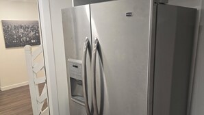 A stainless steel refrigerator with a control panel, a white door, and a handle. - Cozy 2-Bedroom Suite: 5 Minutes Walk To Chestermere Lake (Chestermere)