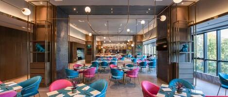 A spacious restaurant with multiple tables and chairs, featuring a modern interior design and large windows.