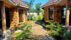 A stone building with a central pathway and small plants. - Lorateng' Resort Rusinga (Rusinga Island)
