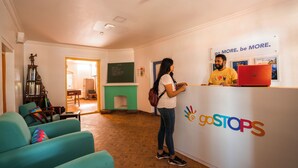 A reception area with a sign reading "goSTOPS" and a motivational slogan above it. - goSTOPS Ooty (Ooty)