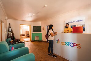 A reception area with a sign reading "goSTOPS" and a motivational slogan above it. - goSTOPS Ooty (Ooty)