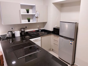 Fridge, microwave, stovetop, coffee/tea maker