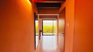 A hallway with a view of a balcony and a door. - 45 m² Soundproof Room with Private Bathroom and Terrace – Up to 4 Guests (Illasi)