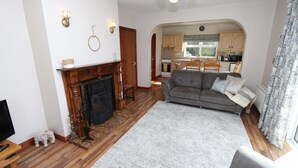 A living room with a fireplace, a sofa, and a television.