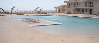 GuestHost - The accommodation (on the ground floor: a step at the entrance) is organized as follows:- LIVING ROOM with KITCHENETTE (induction hob, fridge, freezer, oven, microwave, kettle, wine glasses and kitchenware), dining table, double sofa bed and 