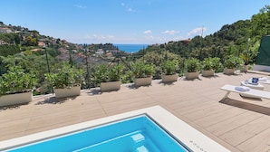 A rooftop pool area with a view of the sea and hills. - The Italian Lady (Alassio)