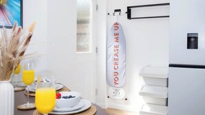A modern kitchen with a breakfast setup, including a fruit bowl, glasses of orange juice, and a white refrigerator.