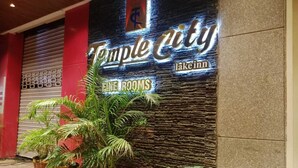 A hotel entrance with a sign reading "Temple City Lake Inn" and "Fine Rooms".