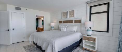 A bedroom with a bed, bedside tables, a wardrobe, and a window.