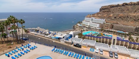 A resort with a pool area, beach, and ocean view.