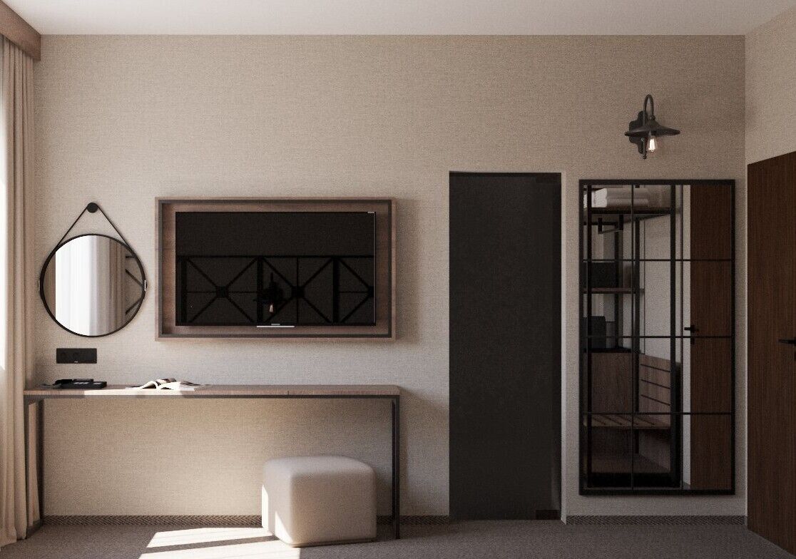 Habitación de hotel moderna con un espejo grande, una obra de arte enmarcada, un escritorio con silla y vista a una escalera.