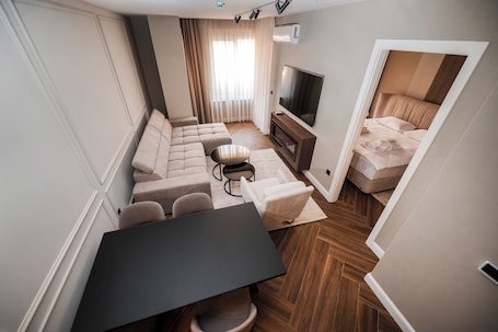 Deluxe Apartment, City View | Living area | 64-inch LED TV with satellite channels