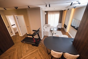 Royal Apartment, Balcony, City View | Living area | 64-inch LED TV with satellite channels, fireplace - Ideal Apartments (Banja Luka)