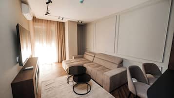 Deluxe Apartment, Balcony, City View | Living area | 64-inch LED TV with satellite channels