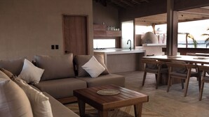 Un espace de vie moderne comprenant un canapé, une table basse et une table à manger.